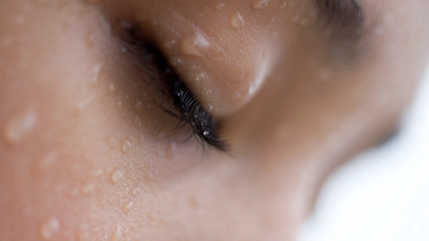 extreme close up of womans face sweating
